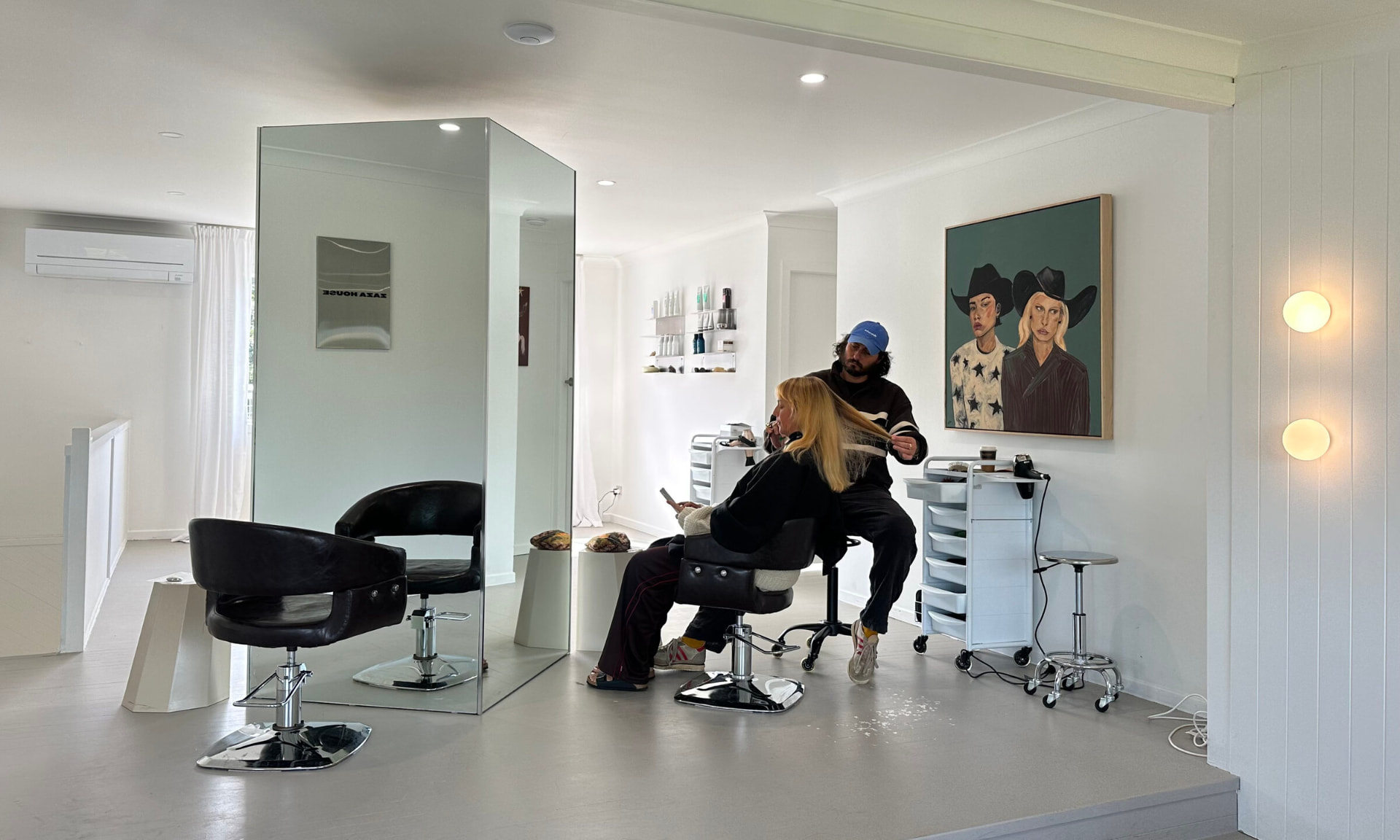 Stylist cutting hair in the Zaza House salon floor