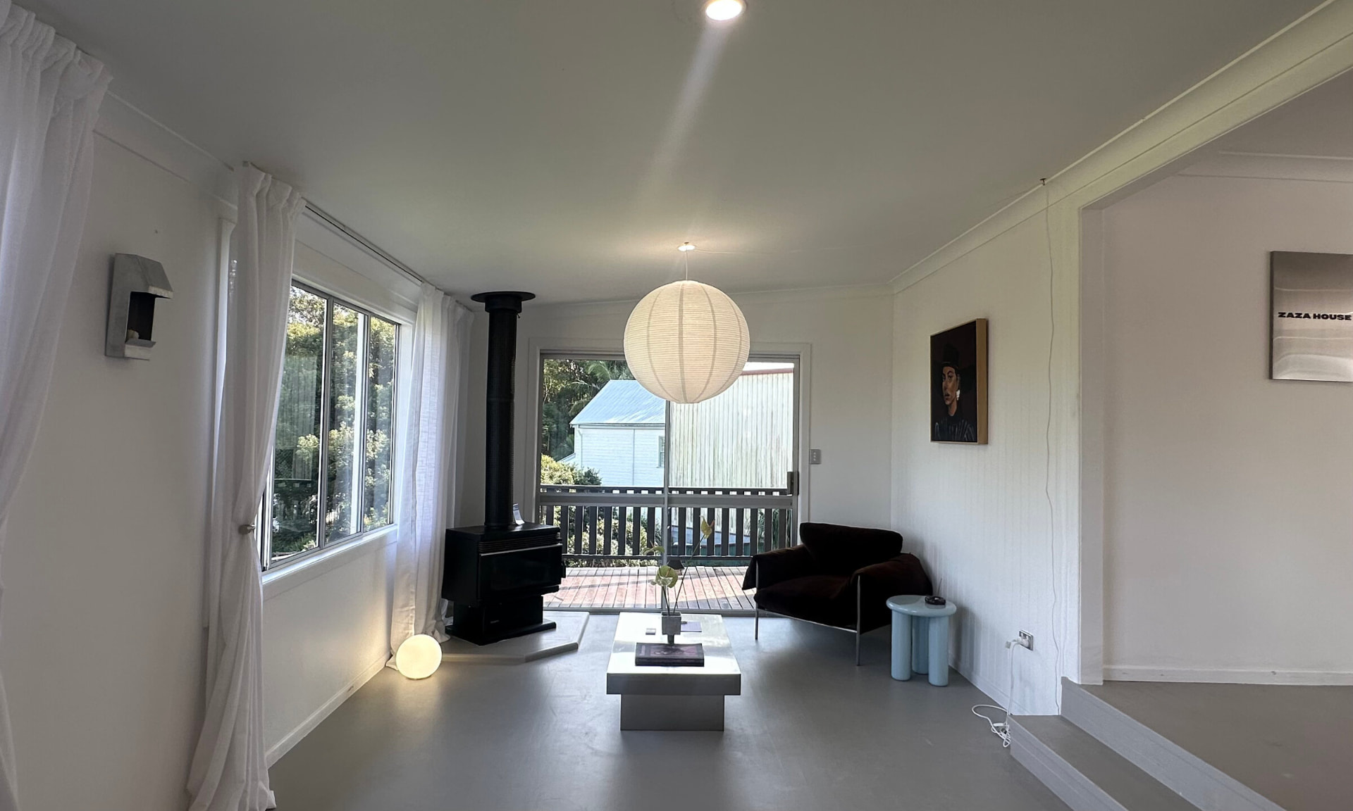 Zaza House lounge with fireplace and deck outlook